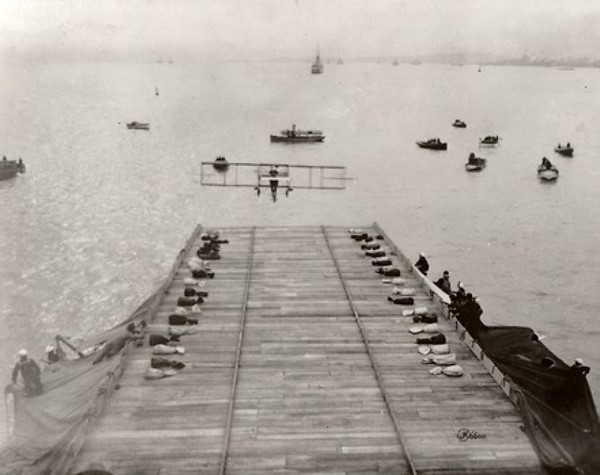 Biplane coming in for a landing on aircraft carrier