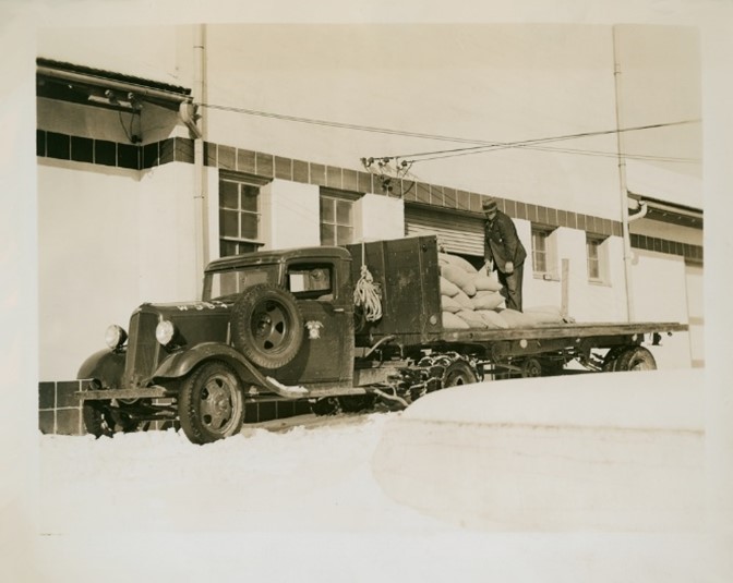 Stucco building with US Army truck parked in front