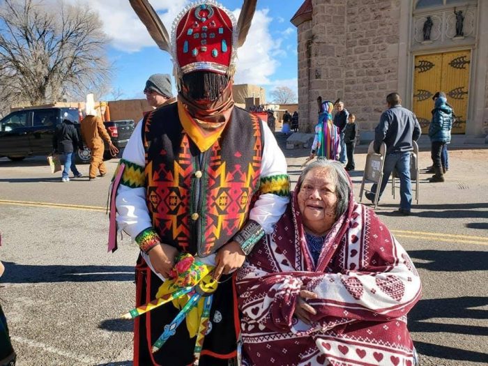 Maheegan Otencio in Native costume poses with his grandmother before a dance performance