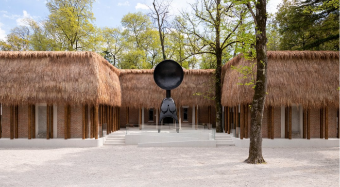 Outdoor installation featuring buildings with thatched roofs