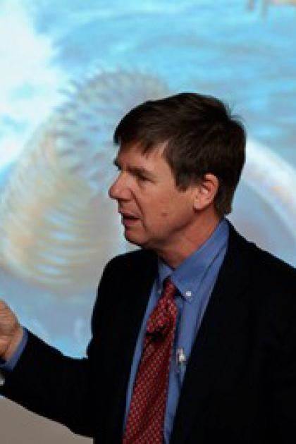 Doug Erein lecturing in front of a screen, left profile