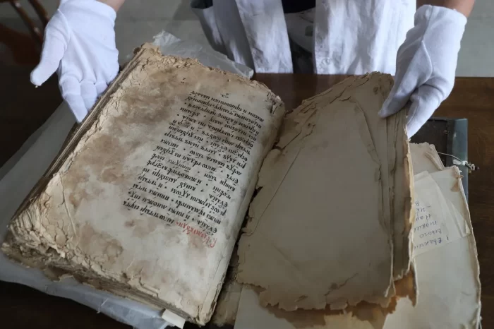 Ancient book with torn, stained pages
