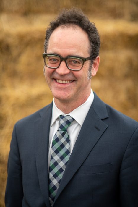 Head shot of Murphy outdoors wearing dark suit