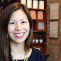 Cropped horizontal photo of Nancy Yao with shelves and artifacts in background