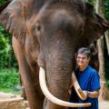 Janine Brown hugs an elephant in Thailand