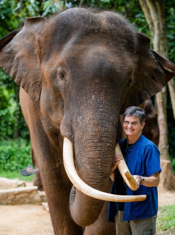 Janine Brown hugs an elephant in Thailand