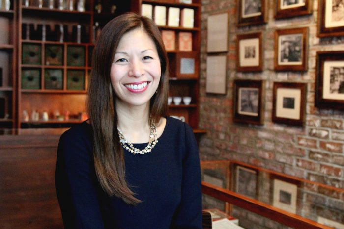 Nancy Yao with books and pictures in backgroun