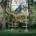 Artist poses with her outdoor installation