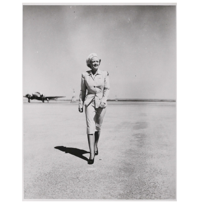 A member if the WASPS in uniform striding across the tarmac