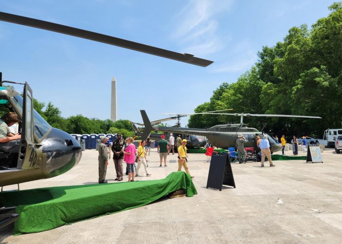 Visitors explore helicopters parked on the mall.