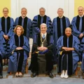 Nine recipients of honorary degrees from Yale pose fo9r group photo, Lonnie Bunch in rear