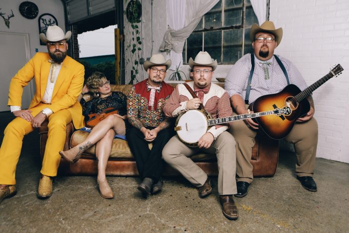 Band Po Ramblin Boys pose while sitting on couch