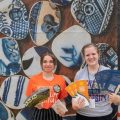 Folklife Festival volunteers holding fans and brochures