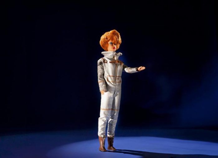 Red-haired Barbie doll from the 1960s in futuristic outfit and brown boots