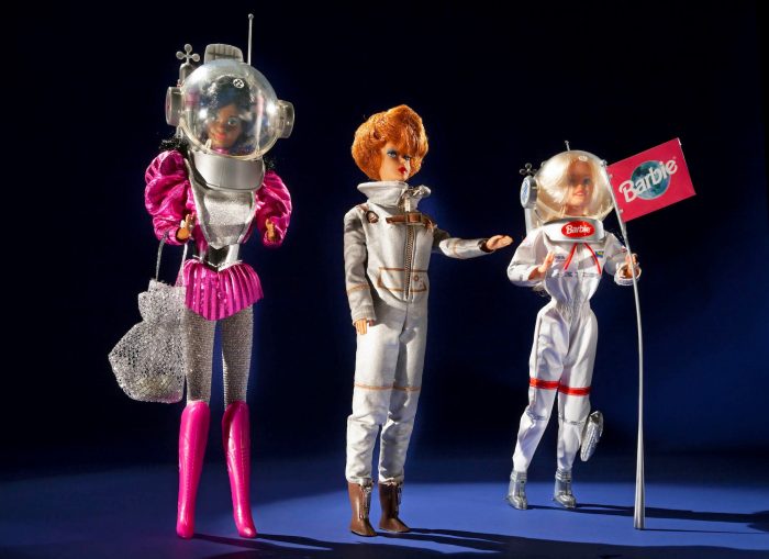 Three Astronaut Barbies from three different eras posed in a row