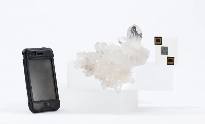 Composite photo of phone, quartz crystal and microchips