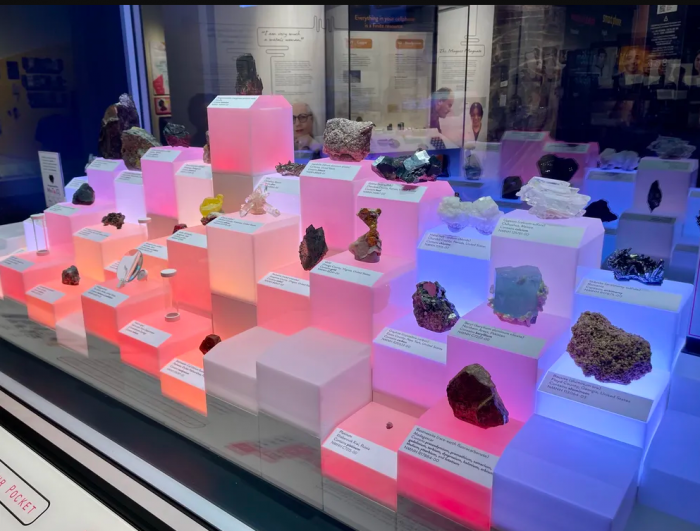 Minerals on display boxes lit from within by pastel lights