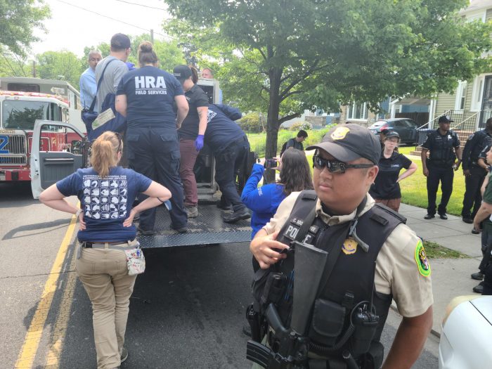 Members of Zoo police, Washington Metro police and the Humane Rescue Alliance gather around truck after bear is captured