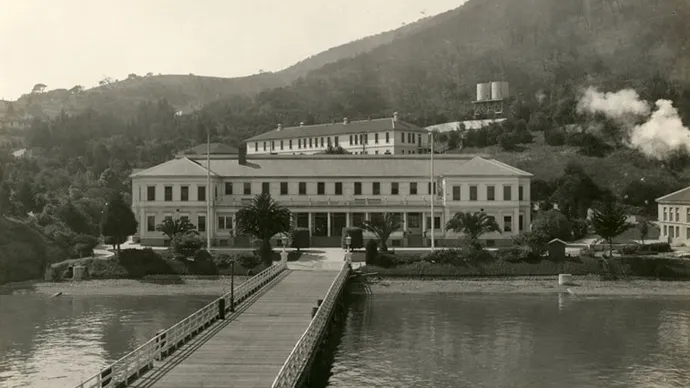 Black and white photo of old immigration station on Angel Island near San Francisco with long pier