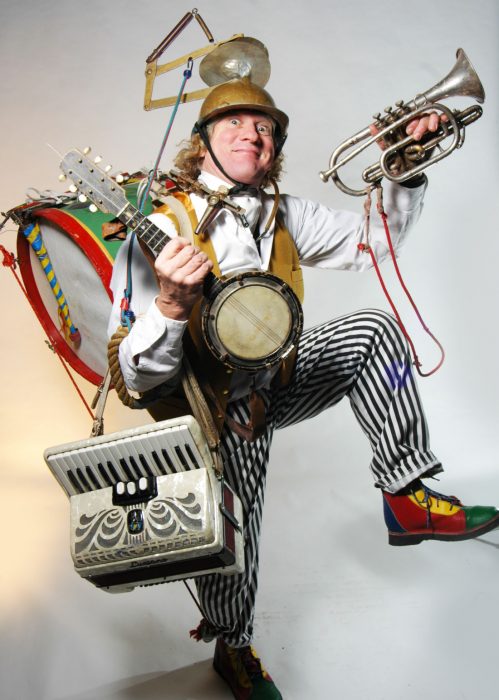 Comical image of performer playing multiple instruments