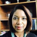 Head shot of Shanita Brackett in front of bookshelves