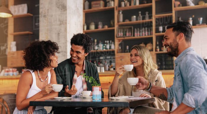 Stock photo of two couples chatting in a coffee shop