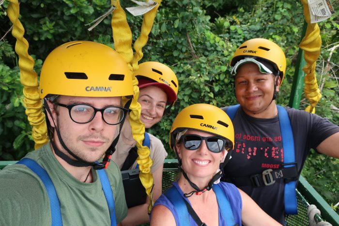 Spear and three members of her team, wearing yellow helmets, in canopy crane