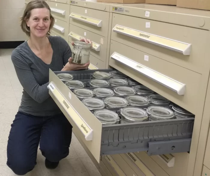 Hannah Wood with jars of specimens in entomology collection