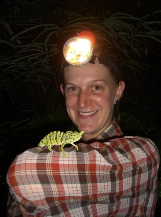 Hannah Wood wearing head lamp with lizard on her arm