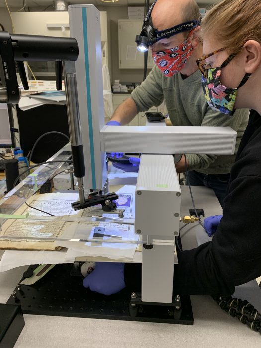 Asher Newsome and student wearing masks in laboratory