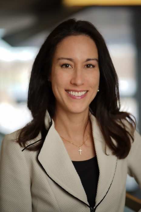 Head shot of Jennifre McIntyre wearing grey jacket and black blouse