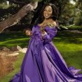 Portrait of Oprah Winfrey outdoors wearing a purple gown