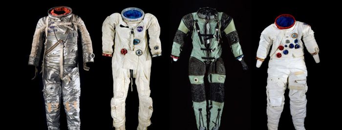 Four spacesuits against a black background