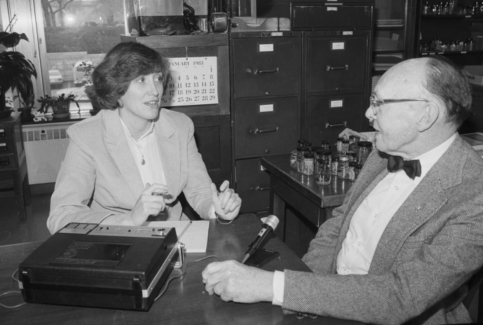 B&W photo of Henson and Hobbs sitting at desk in front of tape recorder