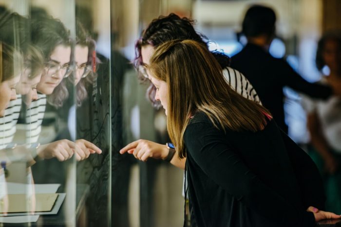 Two women peering into a display case at the National Portrait Gallery