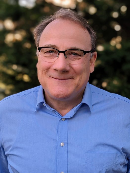 Head shot of Peter Leimgruber wearing a blue shirt