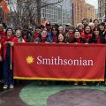 Group shot of participants in 2024 Lunar New Year parade holding red Smithsonian banner