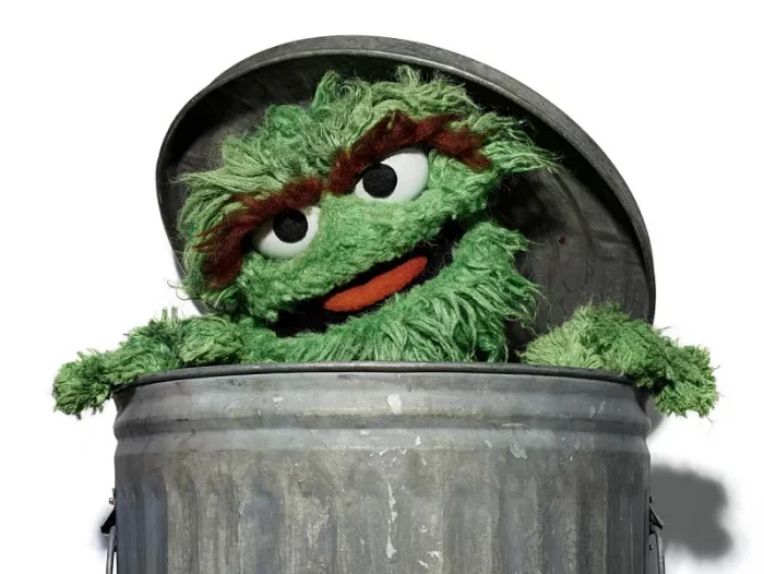 Collection image of Oscar the Grouch muppet in trademrk trash can