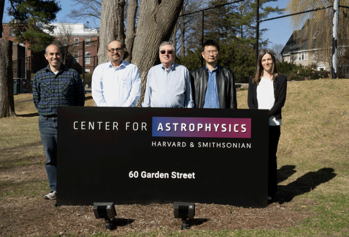 Group shot of TEMPO team standing behind sign for the Center for Astrophysics