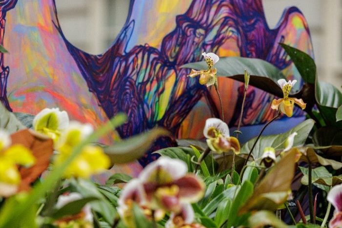 Live orchids in foreground; artists models in background