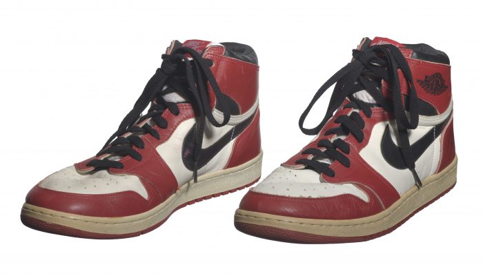 Red, white and black leather basketball shoes with Nike swoosh on the side