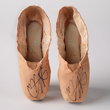 Tattered pink ballet shoes with autograph