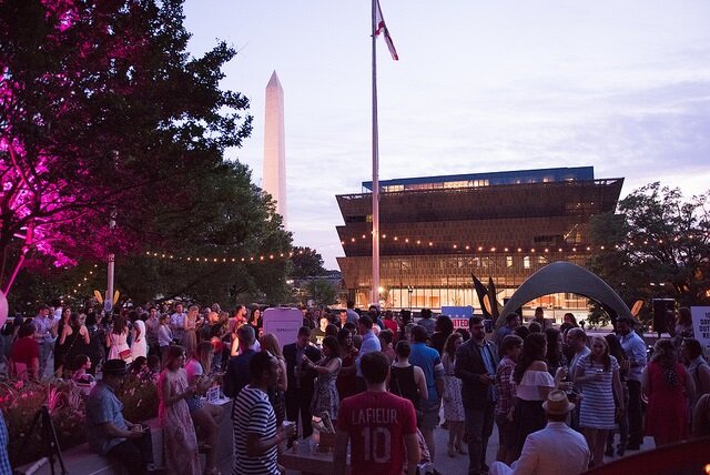 Crowd in front of NMAAHC at twilight