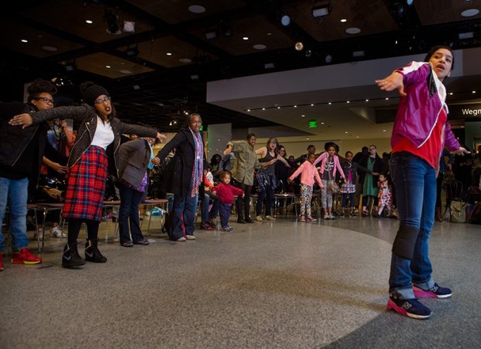 Group learning a line dance from instructor