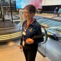 Mary Dominiak, in NASM shirt and volunteer badge, prepares to greet visitors.