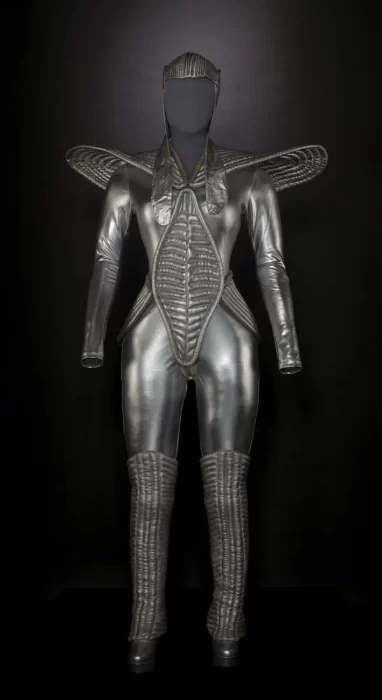 A futuristic silver costume with shoulder "wings" and a headpiece photographed against a black background