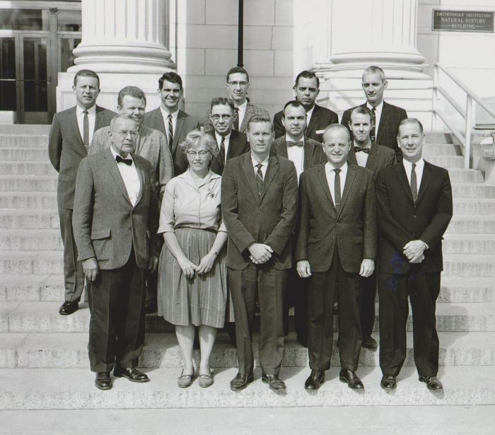 Male and one female curator pose on steps of NMNH in 1965