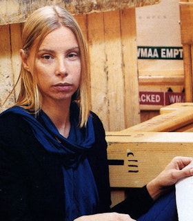 Portrait of unsmiling artist in studio