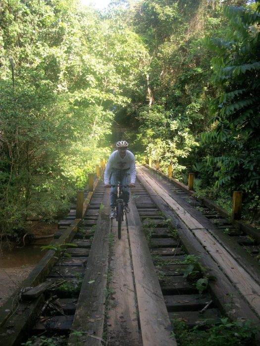 Marty Arthur riding a bike along a disused railway trestle