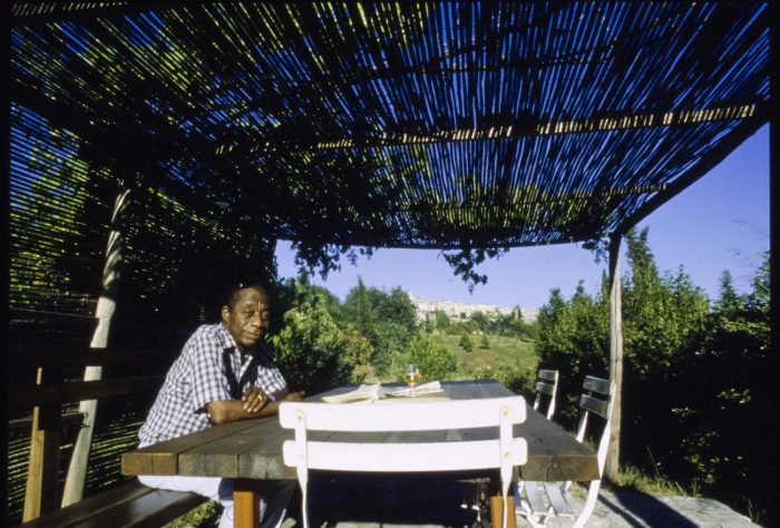 James Baldwin sitting on the terrace of his home in France